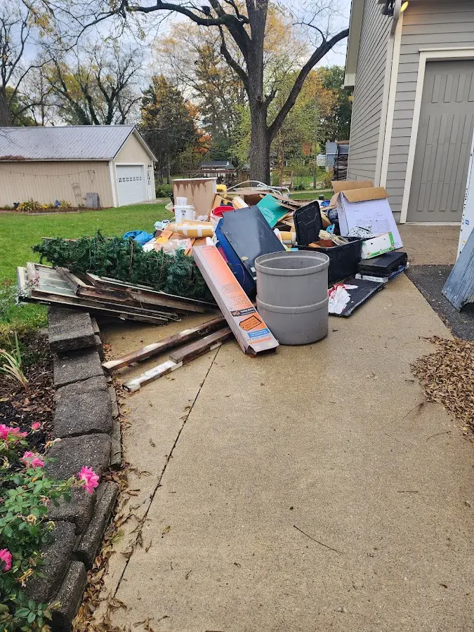 Dumpster being loaded with debris for 30 Yard Dumpster Rental in Natick
